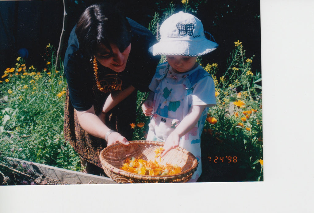 Owner and Founder Beth Lischeron with her daughter Katie (age 2), harvesting calendula in the garden